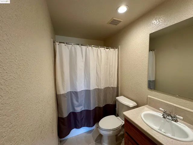 a bathroom with a toilet a sink and a mirror