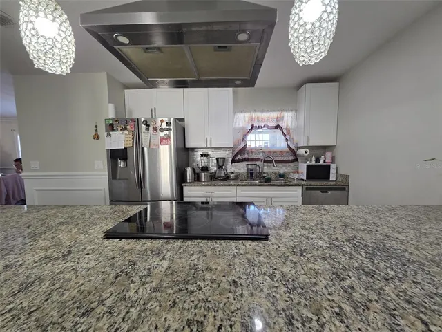 a living room with furniture and wooden floors