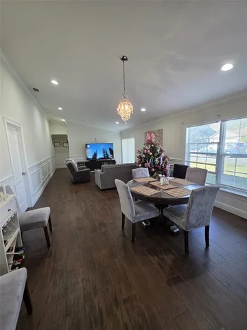 a spacious bedroom with a bed and a dresser in it