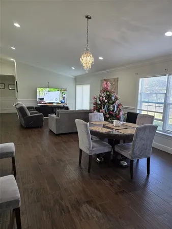 a bed room with a bed and a chandelier