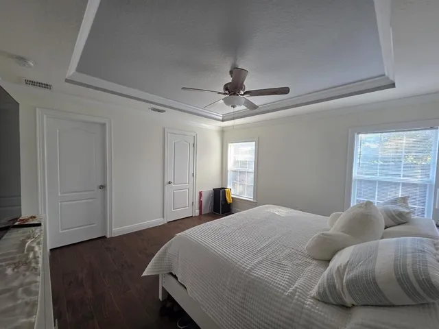 a bedroom with a bed and a chandelier