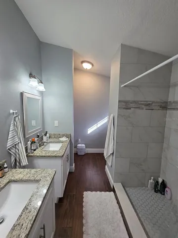 a bathroom with a toilet a sink and shower