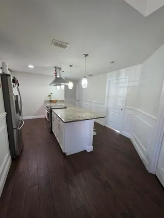 a kitchen with sink and cabinets