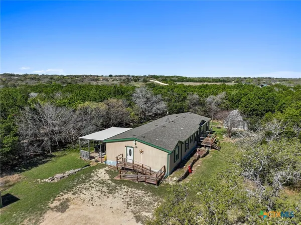 an aerial view of a house with big yard