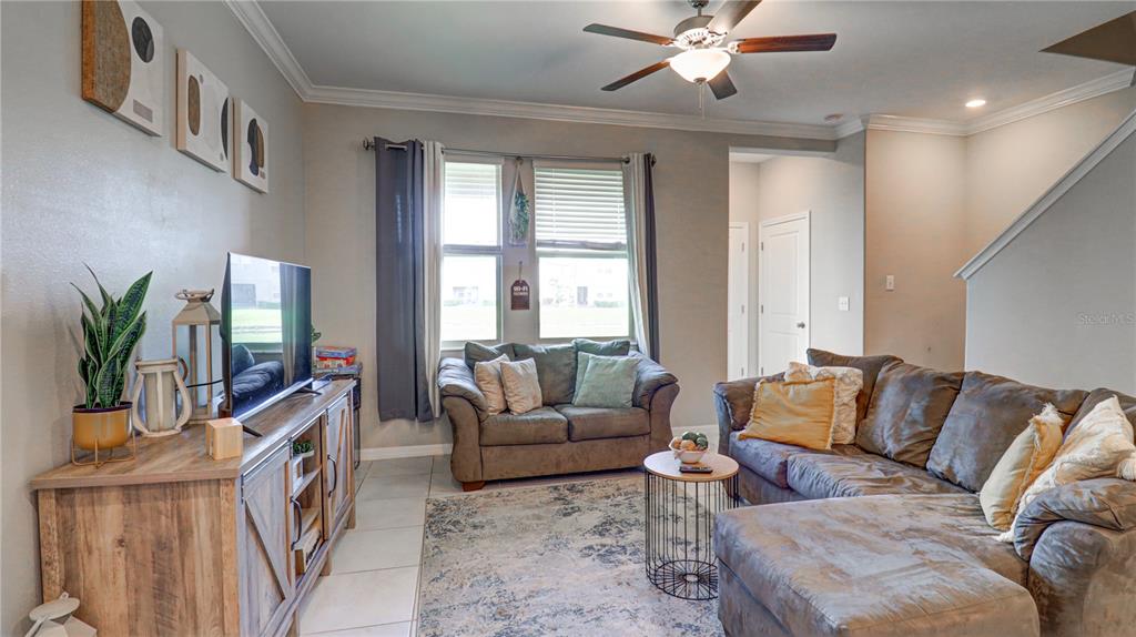 31632 Blue Passing Loop Wesley Chapel, FL 33545 - Photo 16 of 48 a living room with furniture and a large window