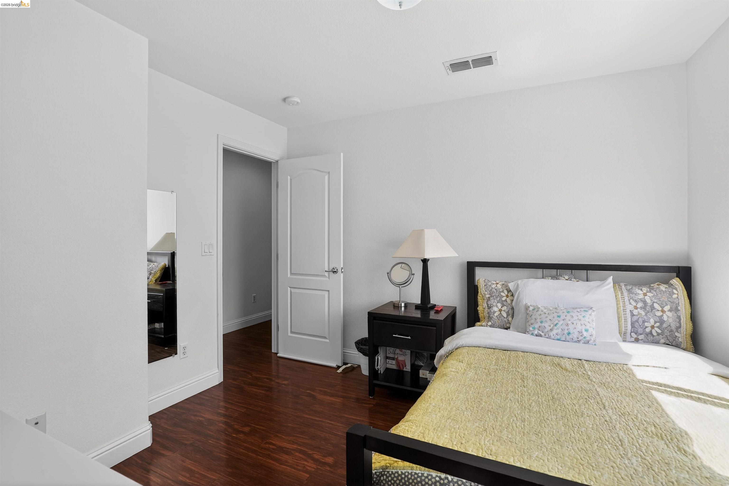 1221 Andrea Way Vallejo, CA 94591 - Photo 23 of 29 Bright room featuring wood-finish flooring, white baseboards, a solid core door with paneling, and a ceiling-mounted ventilation register