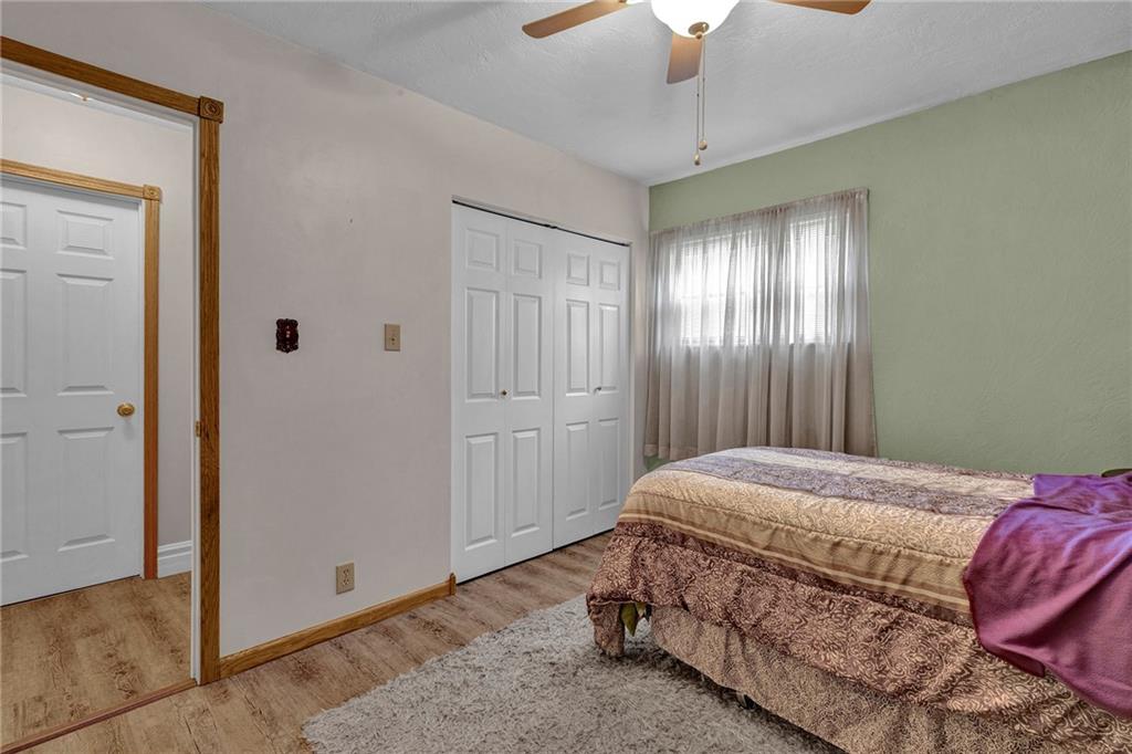 754 Wolf Avenue Rochester, PA 15074 - Photo 15 of 25 a bedroom with a bed and a chandelier fan
