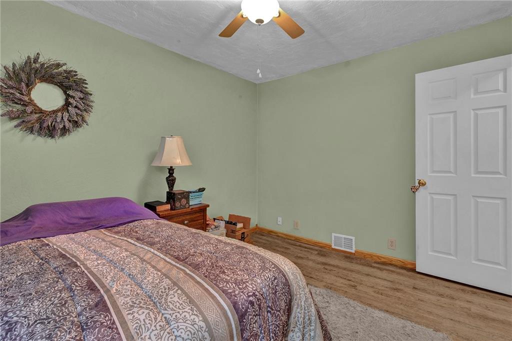 754 Wolf Avenue Rochester, PA 15074 - Photo 16 of 25 a bedroom with a bed and a chandelier