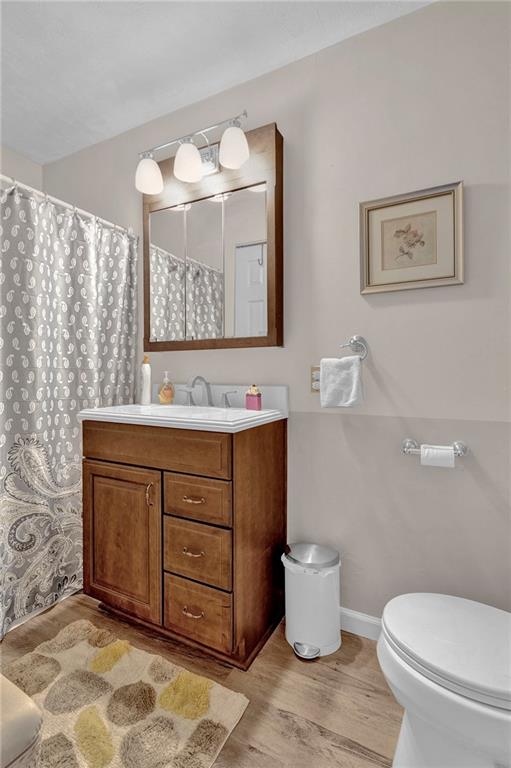 754 Wolf Avenue Rochester, PA 15074 - Photo 18 of 25 a bathroom with a toilet sink and mirror