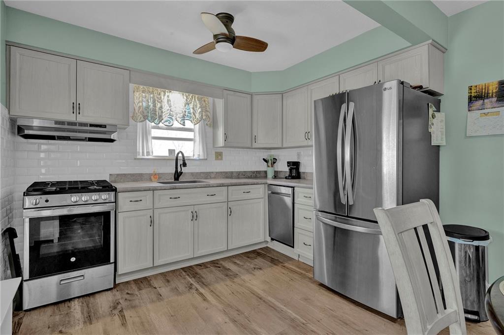 754 Wolf Avenue Rochester, PA 15074 - Photo 6 of 25 a kitchen with cabinets stainless steel appliances a sink and a window