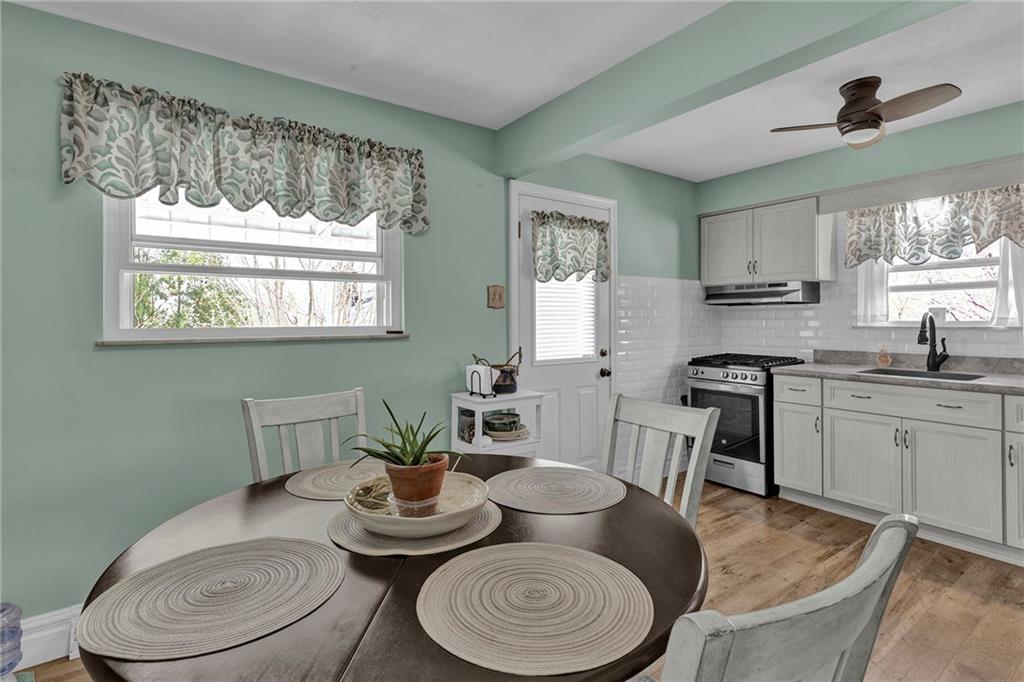 754 Wolf Avenue Rochester, PA 15074 - Photo 7 of 25 a kitchen with a table chairs stove and sink
