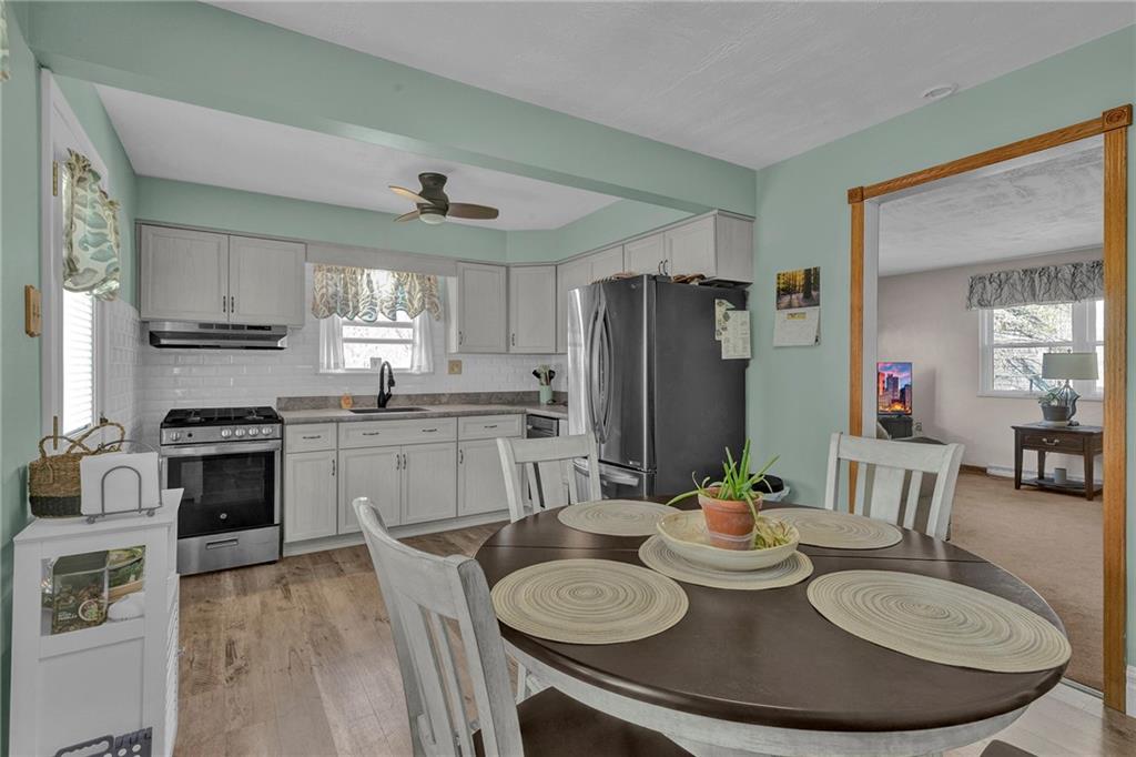 754 Wolf Avenue Rochester, PA 15074 - Photo 8 of 25 a kitchen with stainless steel appliances granite countertop a kitchen island hardwood floor and a sink