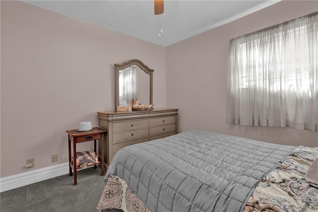 754 Wolf Avenue Rochester, PA 15074 - Photo 10 of 25 a bedroom with a bed and a mirror on dresser