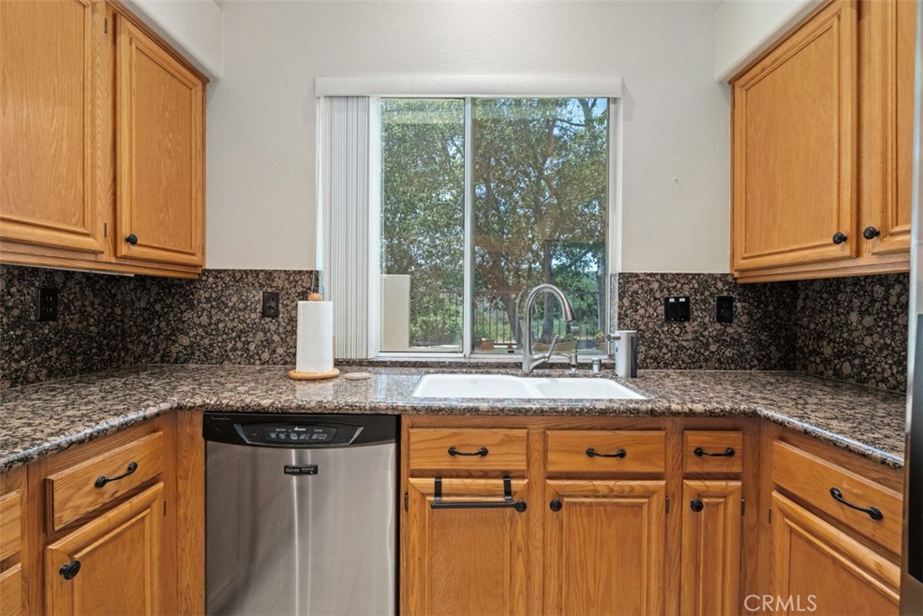 35 Vía Encanto Rancho Santa Margarita, CA 92688 - Photo 12 of 40 a kitchen with granite countertop white cabinets and a window