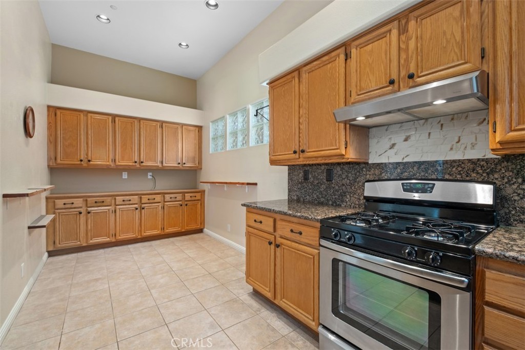 35 Vía Encanto Rancho Santa Margarita, CA 92688 - Photo 13 of 40 a kitchen with stainless steel appliances granite countertop a stove a sink and a refrigerator