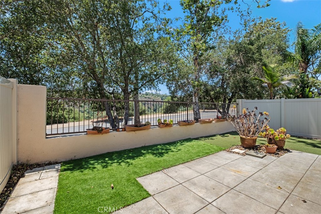 35 Vía Encanto Rancho Santa Margarita, CA 92688 - Photo 15 of 40 a view of a patio with chair and table and chairs next to a yard