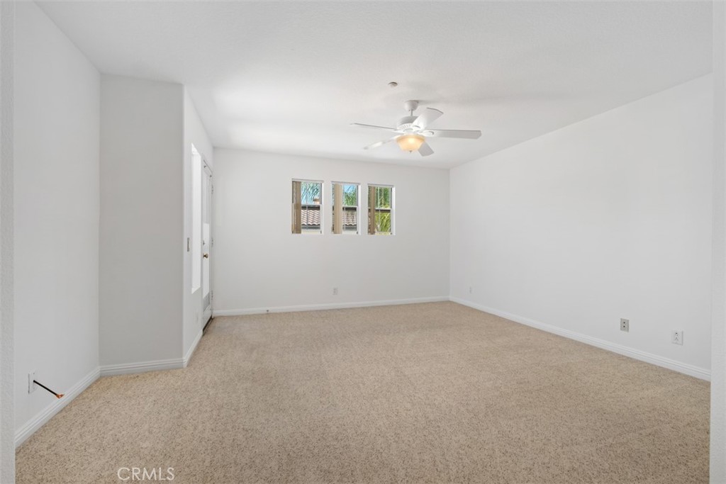 35 Vía Encanto Rancho Santa Margarita, CA 92688 - Photo 21 of 40 an empty room with a window and a ceiling fan