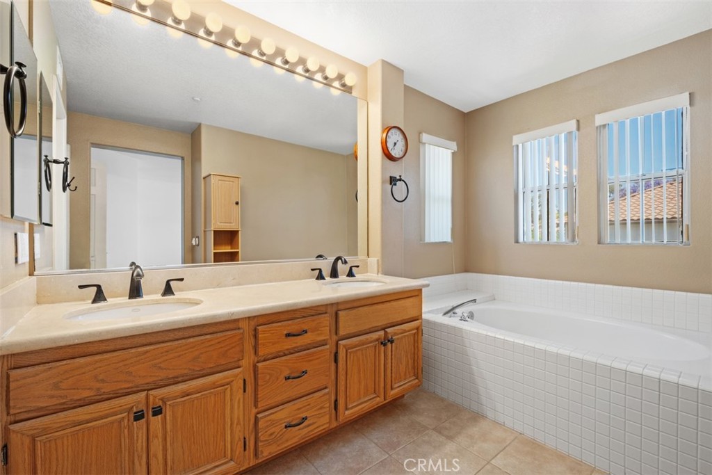 35 Vía Encanto Rancho Santa Margarita, CA 92688 - Photo 22 of 40 a bathroom with a tub double sink window and mirror