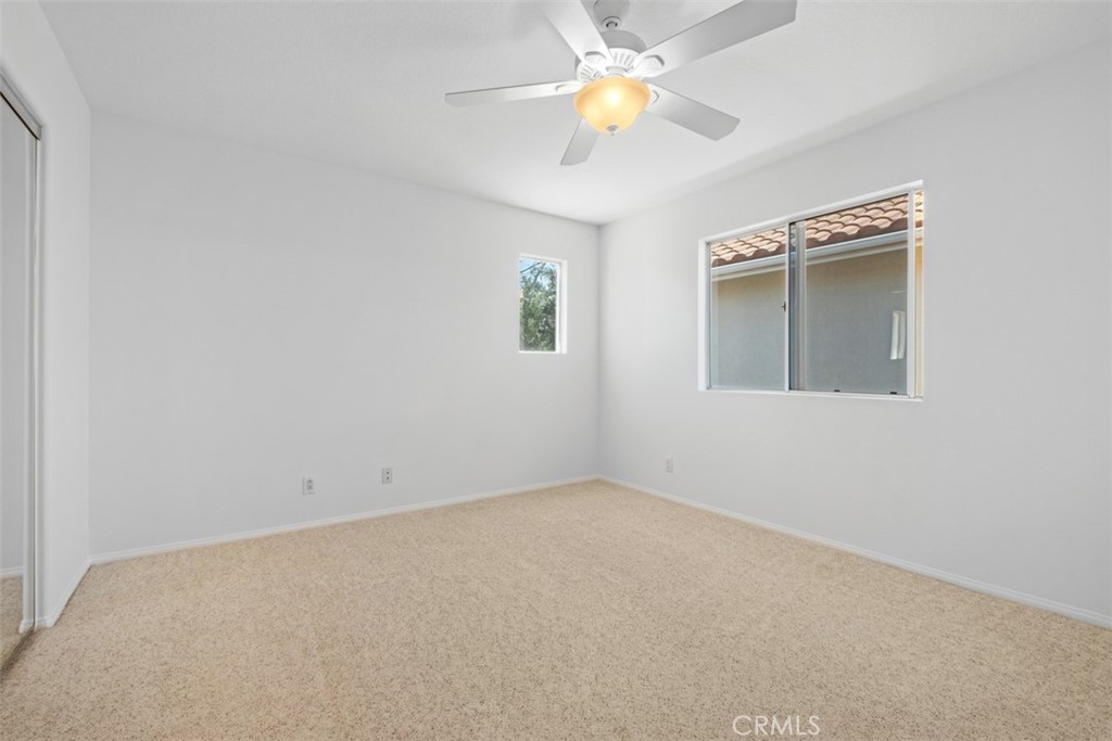 35 Vía Encanto Rancho Santa Margarita, CA 92688 - Photo 29 of 40 an empty room with a window and chandelier fan