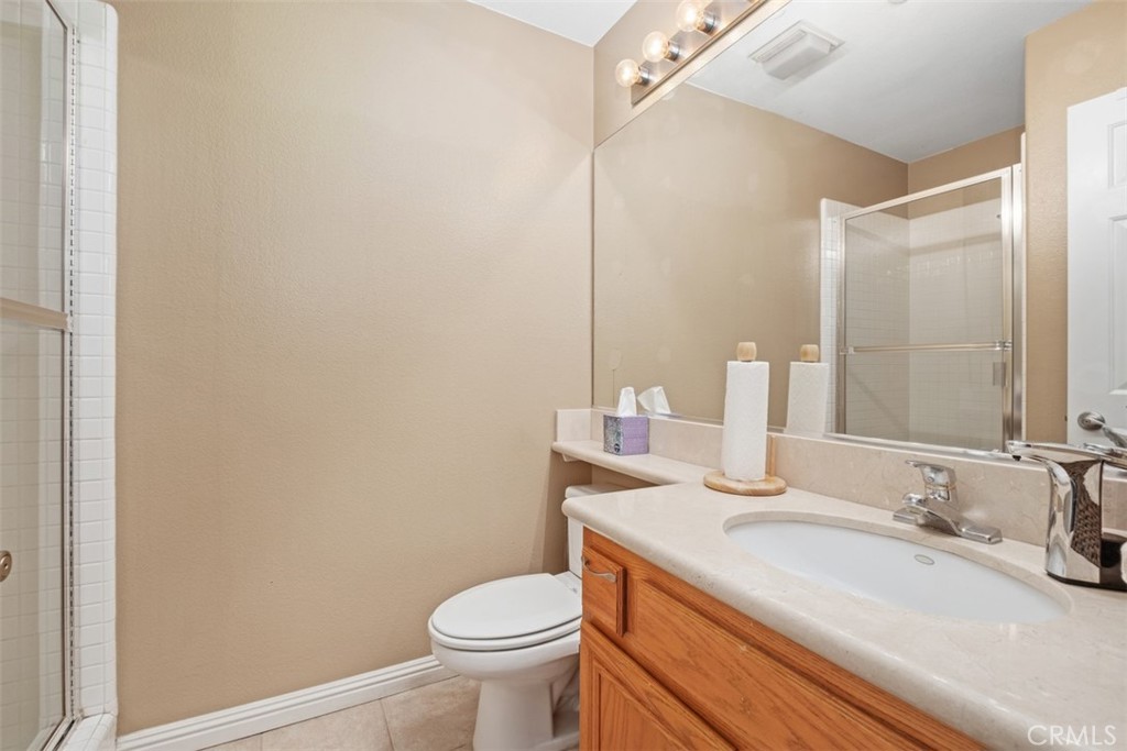 35 Vía Encanto Rancho Santa Margarita, CA 92688 - Photo 30 of 40 a bathroom with a granite countertop sink and a mirror