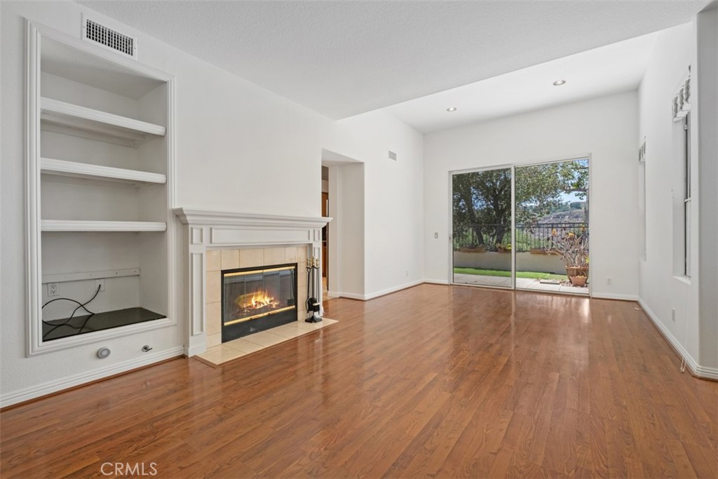 35 Vía Encanto Rancho Santa Margarita, CA 92688 - Photo 3 of 40 a view of empty room with wooden floor and fireplace