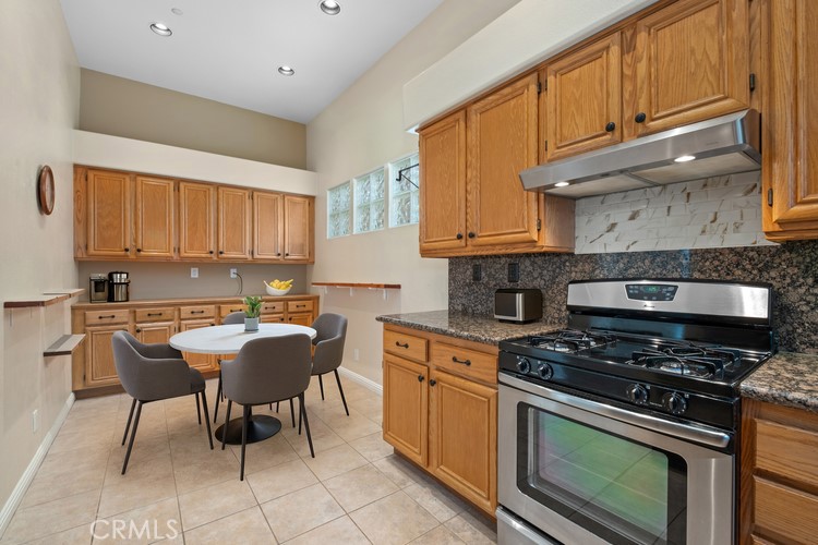 35 Vía Encanto Rancho Santa Margarita, CA 92688 - Photo 38 of 40 a kitchen with a stove a sink and cabinets