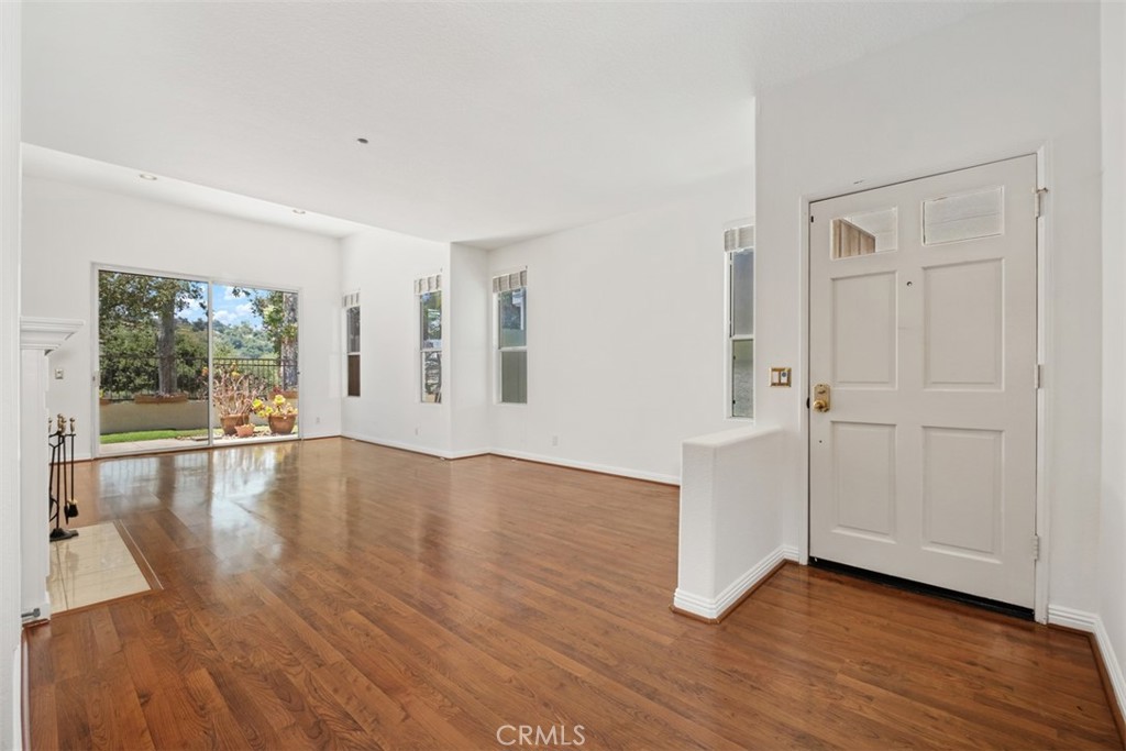 35 Vía Encanto Rancho Santa Margarita, CA 92688 - Photo 4 of 40 a view of empty room with wooden floor and fan