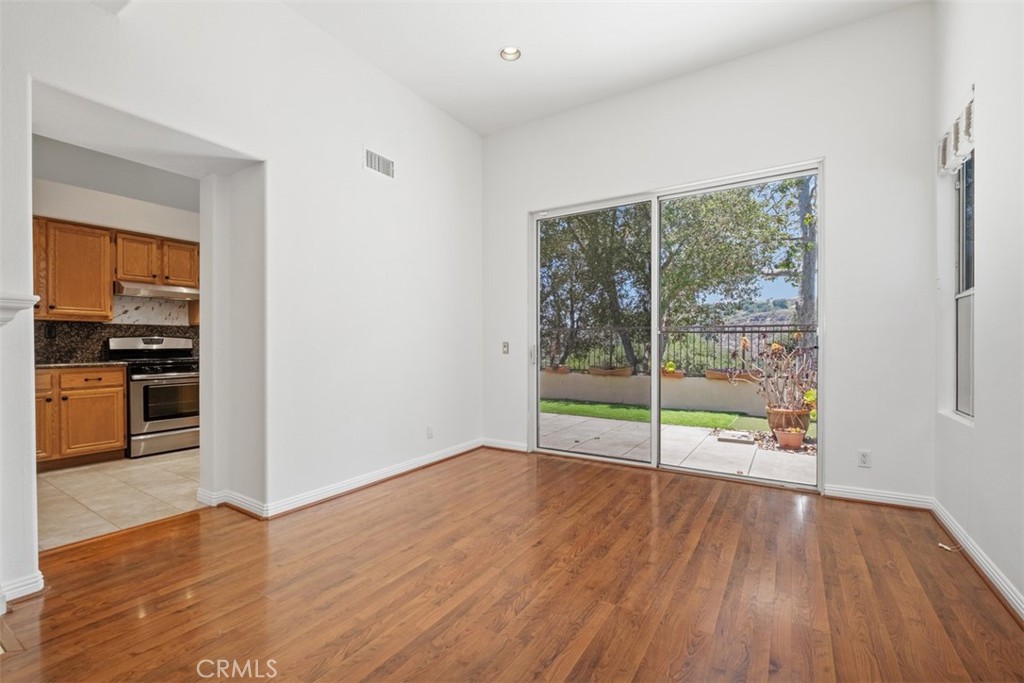 35 Vía Encanto Rancho Santa Margarita, CA 92688 - Photo 8 of 40 a view of empty room with wooden floor and fan