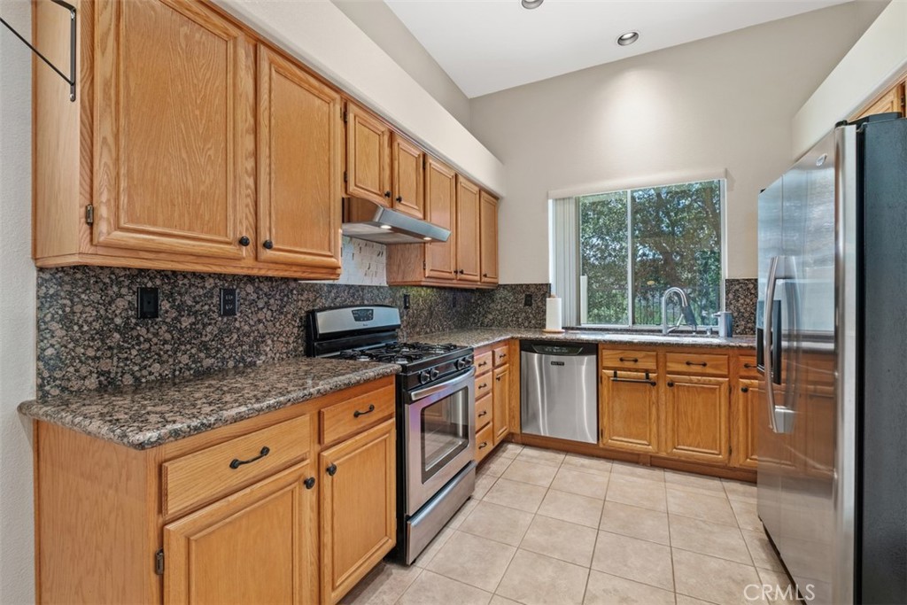 35 Vía Encanto Rancho Santa Margarita, CA 92688 - Photo 10 of 40 a kitchen with stainless steel appliances granite countertop a stove a sink and a granite counter tops