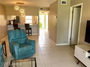 a living room with furniture and a dining table