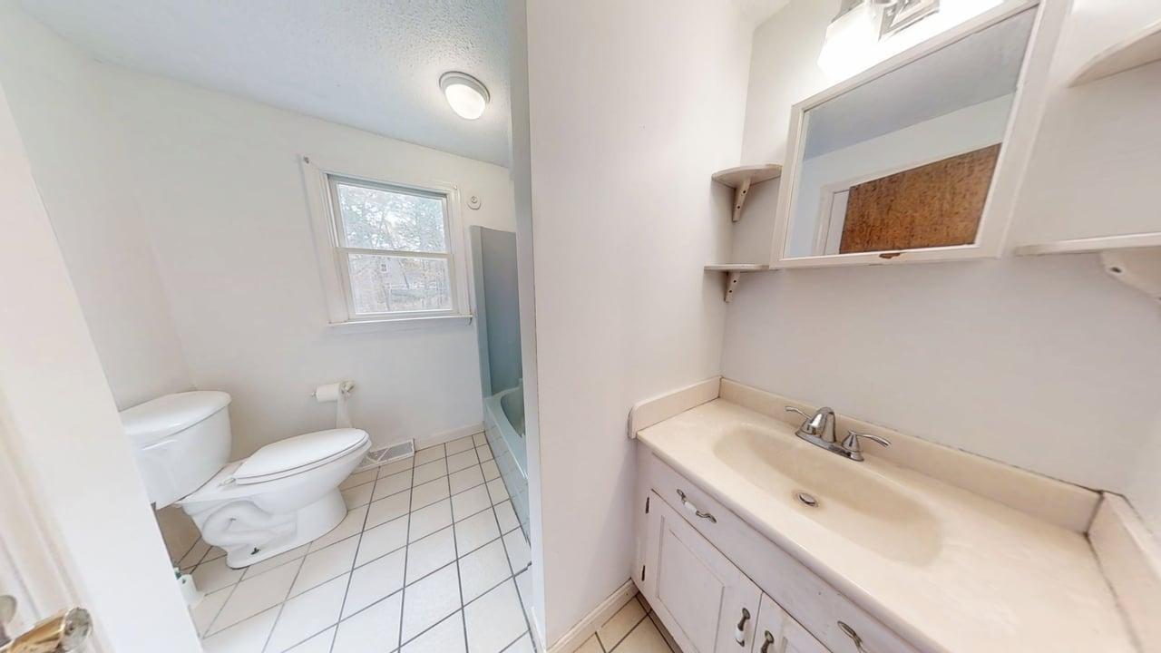 765 Millstone Road Brewster, MA 02631 - Photo 12 of 16 a bathroom with a sink toilet and mirror