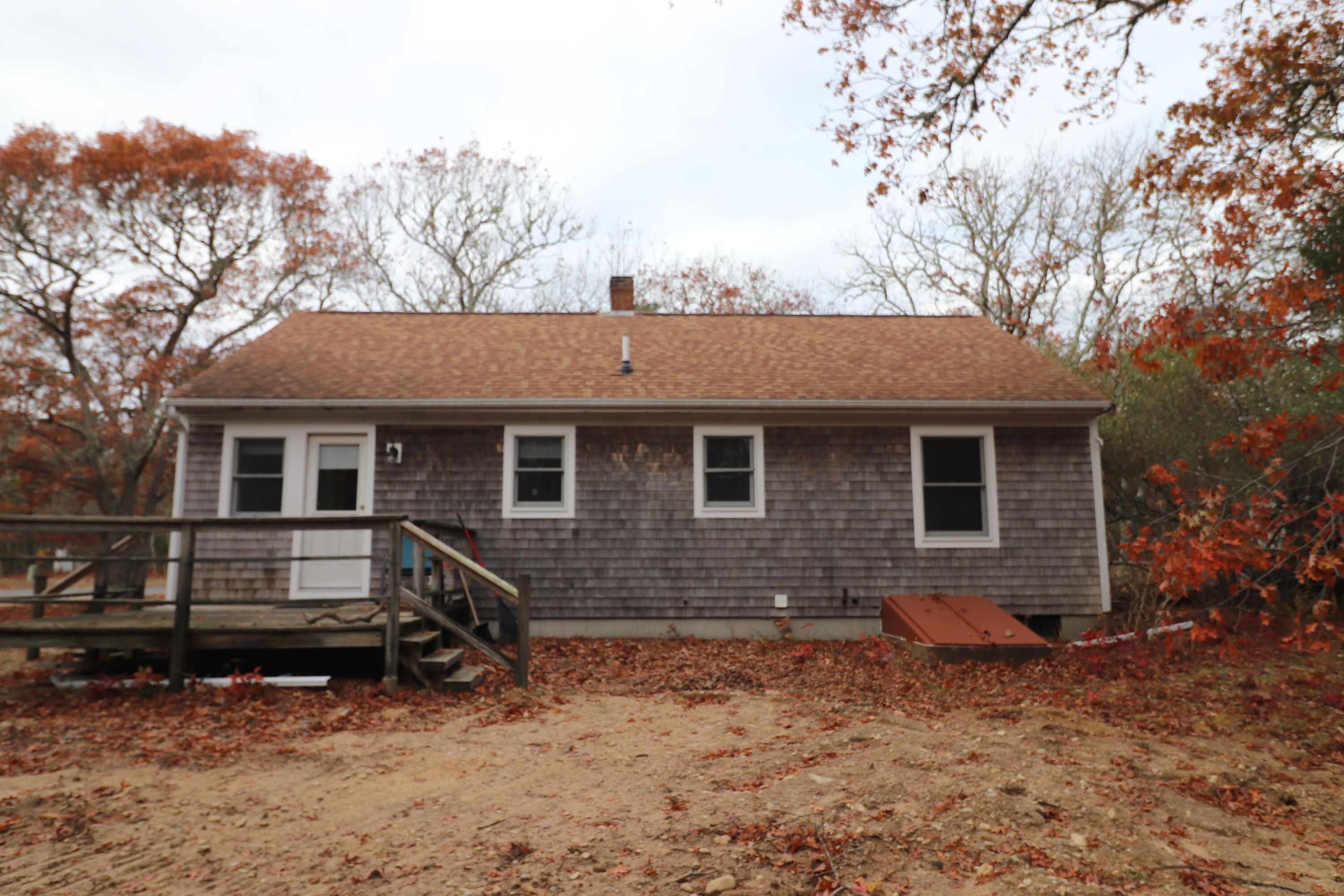 765 Millstone Road Brewster, MA 02631 - Photo 14 of 16 a view of house with a yard
