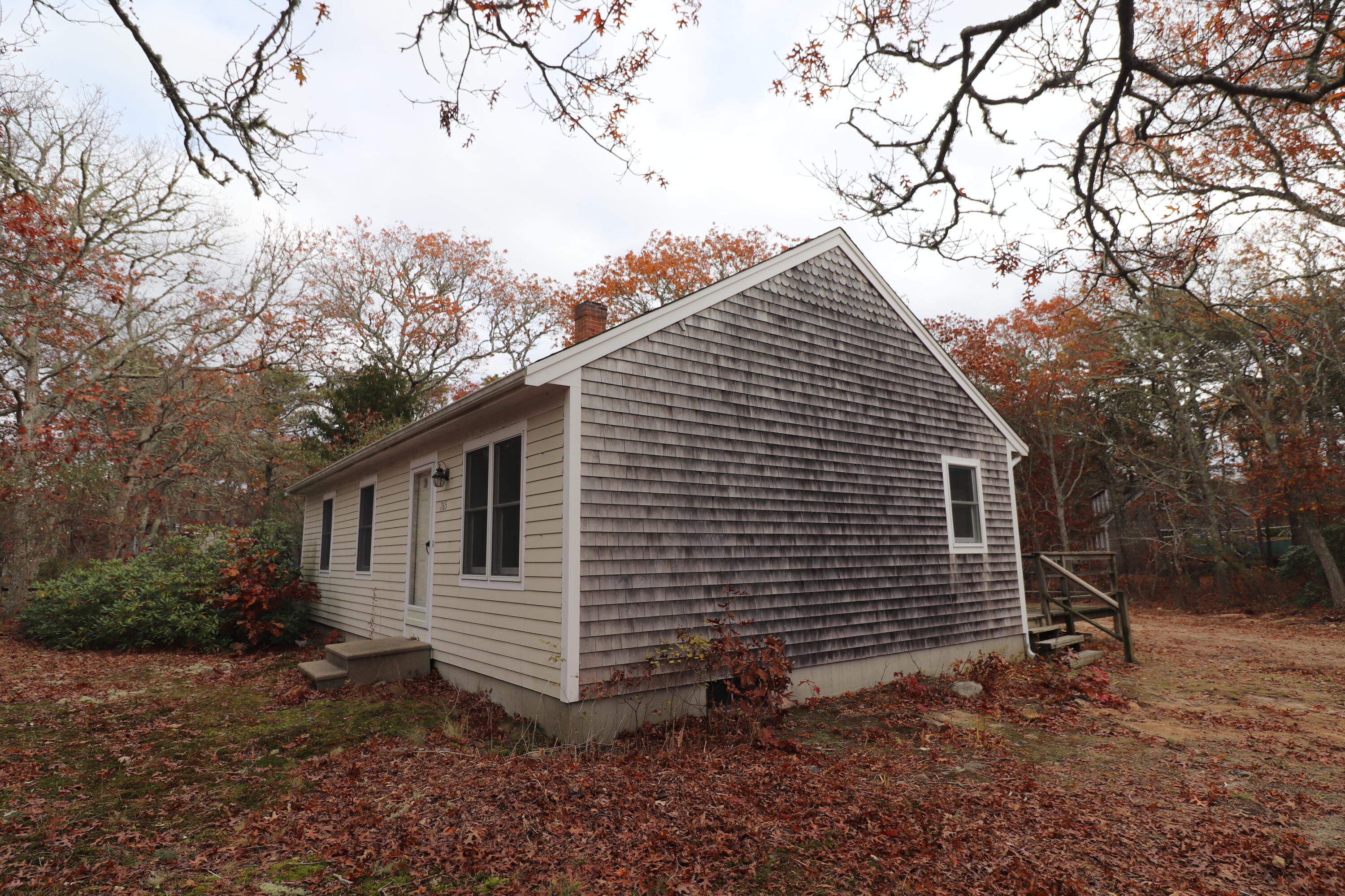 765 Millstone Road Brewster, MA 02631 - Photo 15 of 16 a view of a house with a yard and tree s