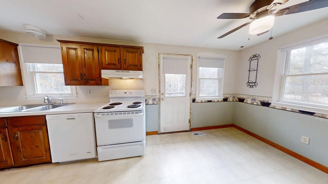 765 Millstone Road Brewster, MA 02631 - Photo 4 of 16 a kitchen with a stove a sink and a refrigerator