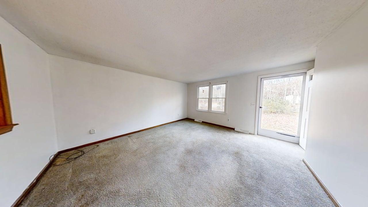 765 Millstone Road Brewster, MA 02631 - Photo 8 of 16 an empty room with windows