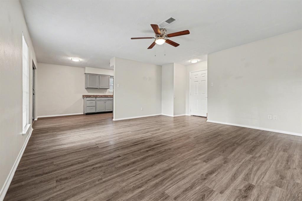 1321 North 7th Street Conroe, TX 77301 - Photo 5 of 17 a view of empty room with wooden floor and window