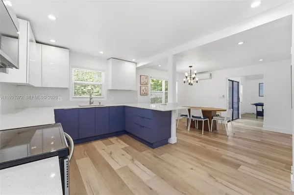 a kitchen with wooden floors and wooden cabinets