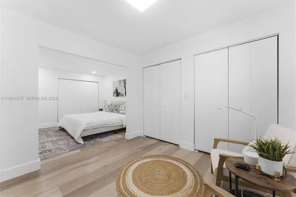 a bedroom with a bed and a potted plant