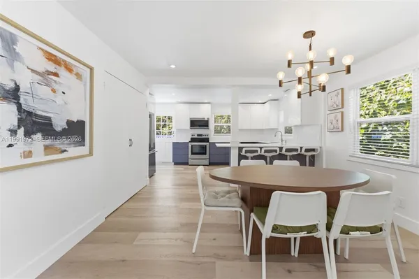 a view of a dining room with furniture and chandelier