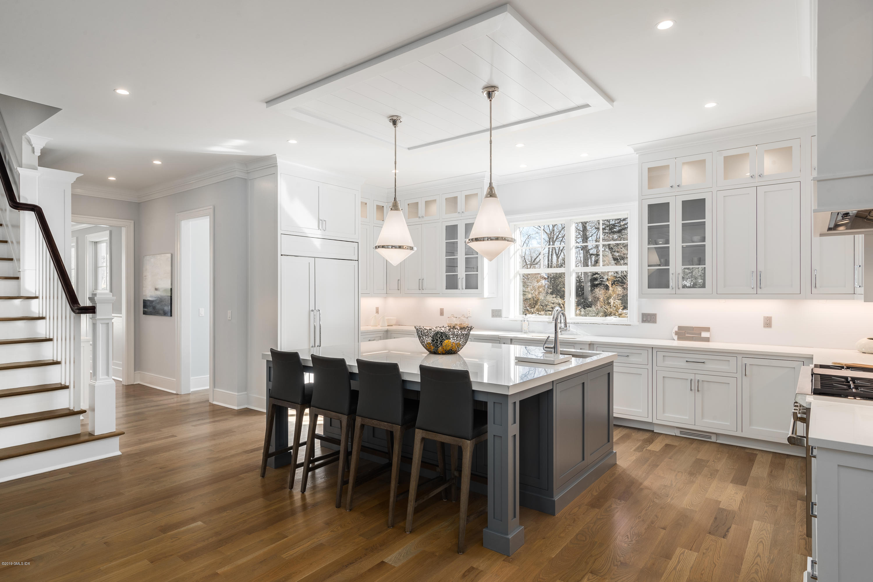22 Mimosa Drive Cos Cob, CT 06807 - Photo 12 of 27 a kitchen with stainless steel appliances kitchen island granite countertop a table chairs sink and cabinets