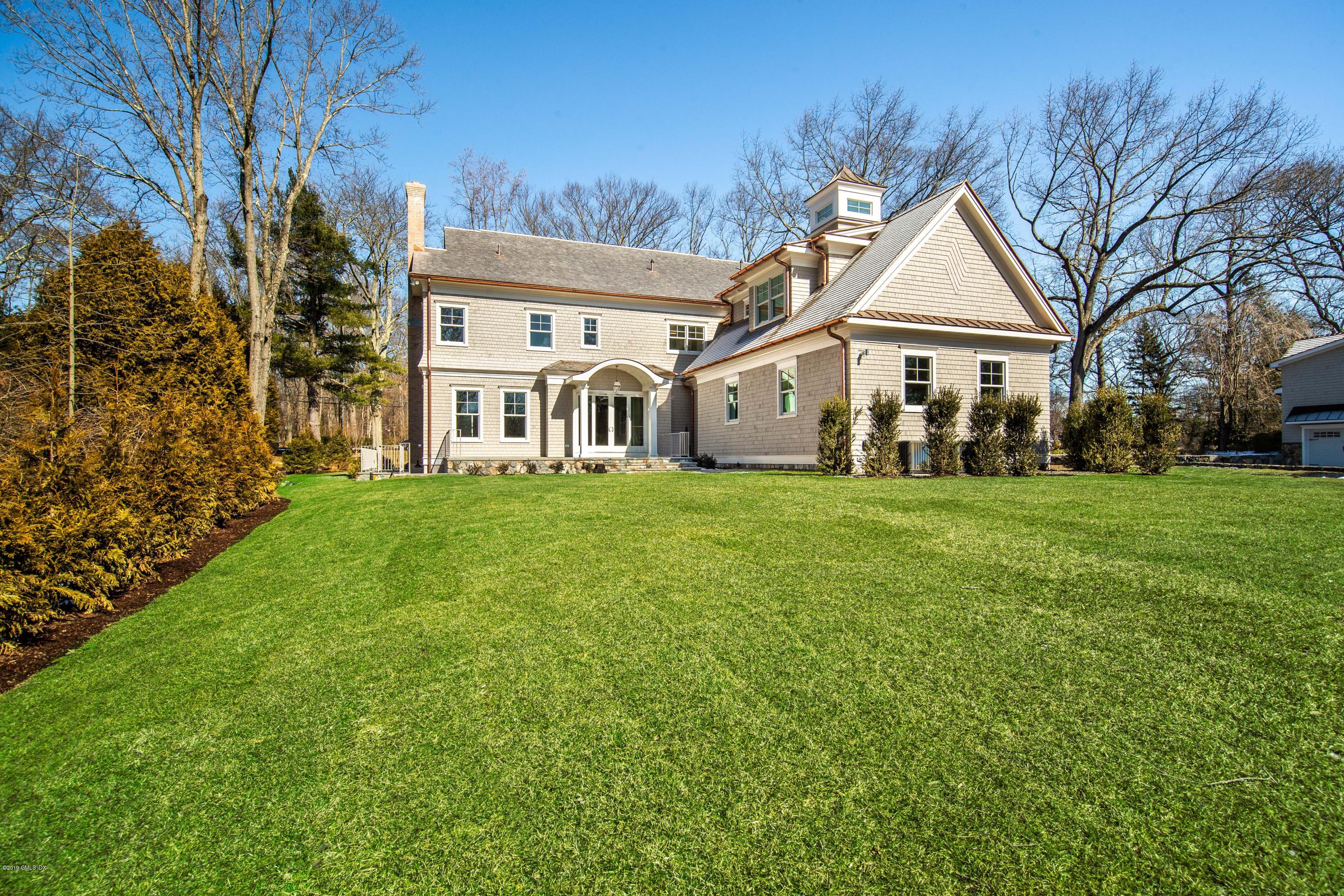 22 Mimosa Drive Cos Cob, CT 06807 - Photo 22 of 27 a view of a white house with a big yard and large trees