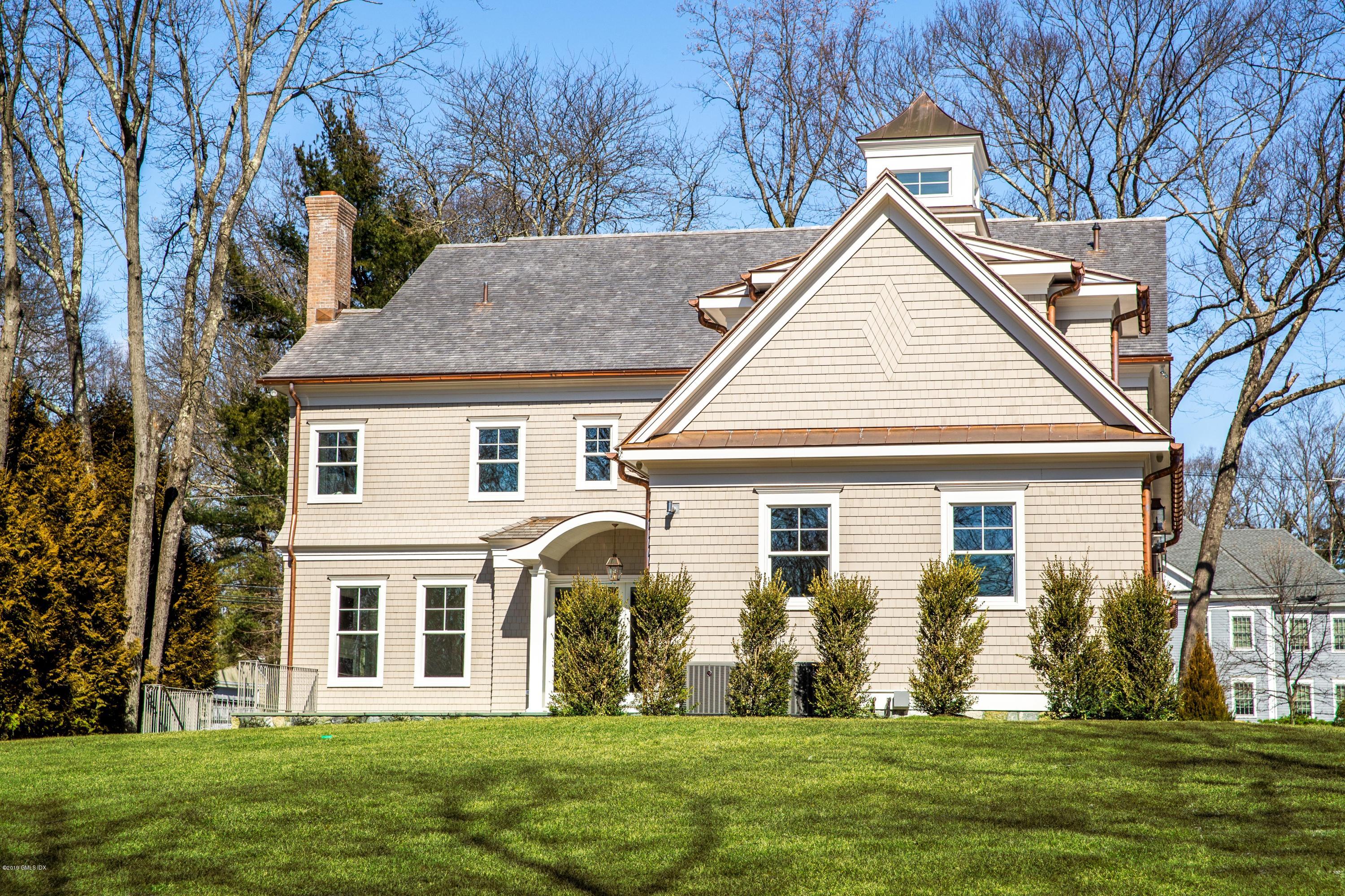 22 Mimosa Drive Cos Cob, CT 06807 - Photo 23 of 27 a front view of house with yard and green space