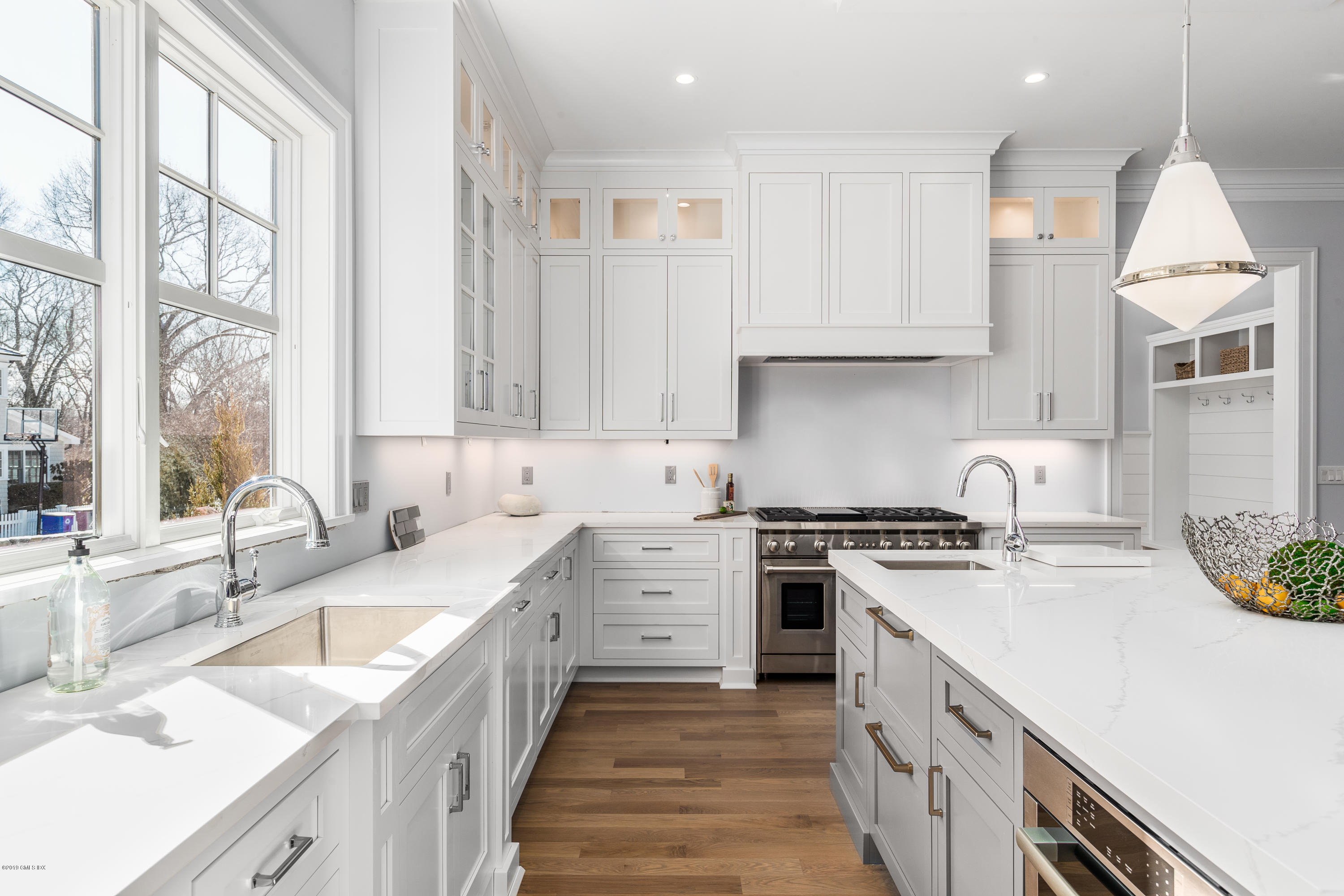 22 Mimosa Drive Cos Cob, CT 06807 - Photo 10 of 27 a kitchen with a sink stove top oven and cabinets