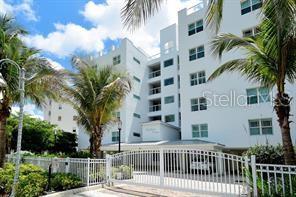 650 Golden Gate Point, Unit 301 Sarasota, FL 34236 - Photo 3 of 31 a view of a white building with a palm tree