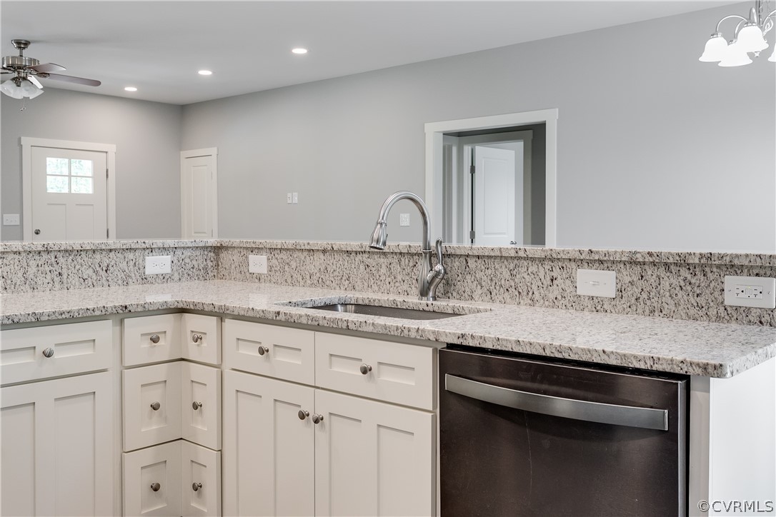 3933 Whitehall Road Sandy Hook, VA 23153 - Photo 4 of 15 a kitchen with granite countertop white cabinets and a sink