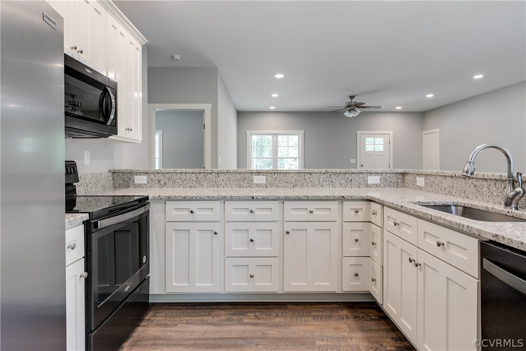 3933 Whitehall Road Sandy Hook, VA 23153 - Photo 5 of 15 a kitchen with white cabinets stainless steel appliances and sink