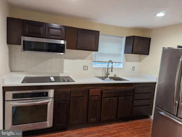 a kitchen with stainless steel appliances a stove microwave and cabinets