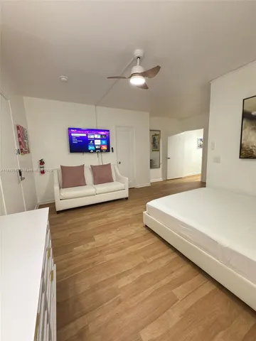 a spacious bedroom with a bed and a chandelier