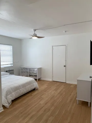 a bedroom with a bed and a night stand