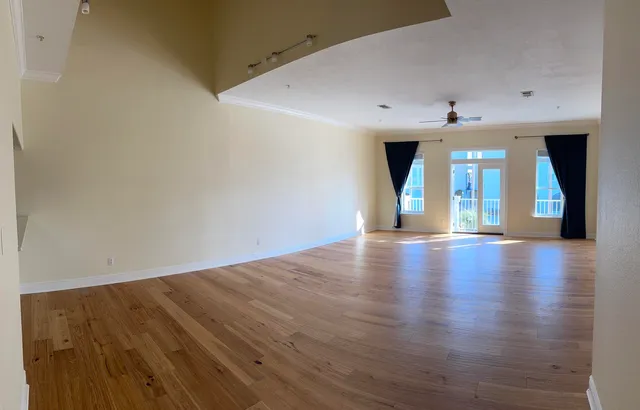 a view of a room with wooden floor